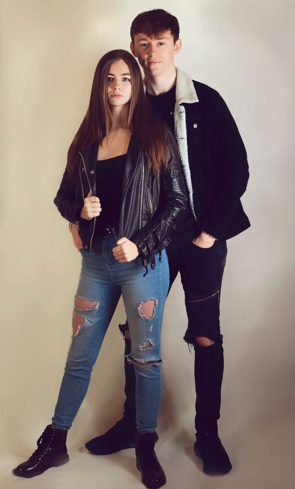 studio fashion shoot of young couple in jeans and jackets