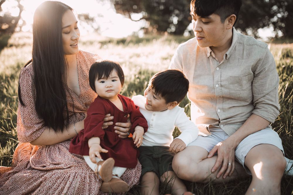 Candid family moments captured during outdoor sunset session.