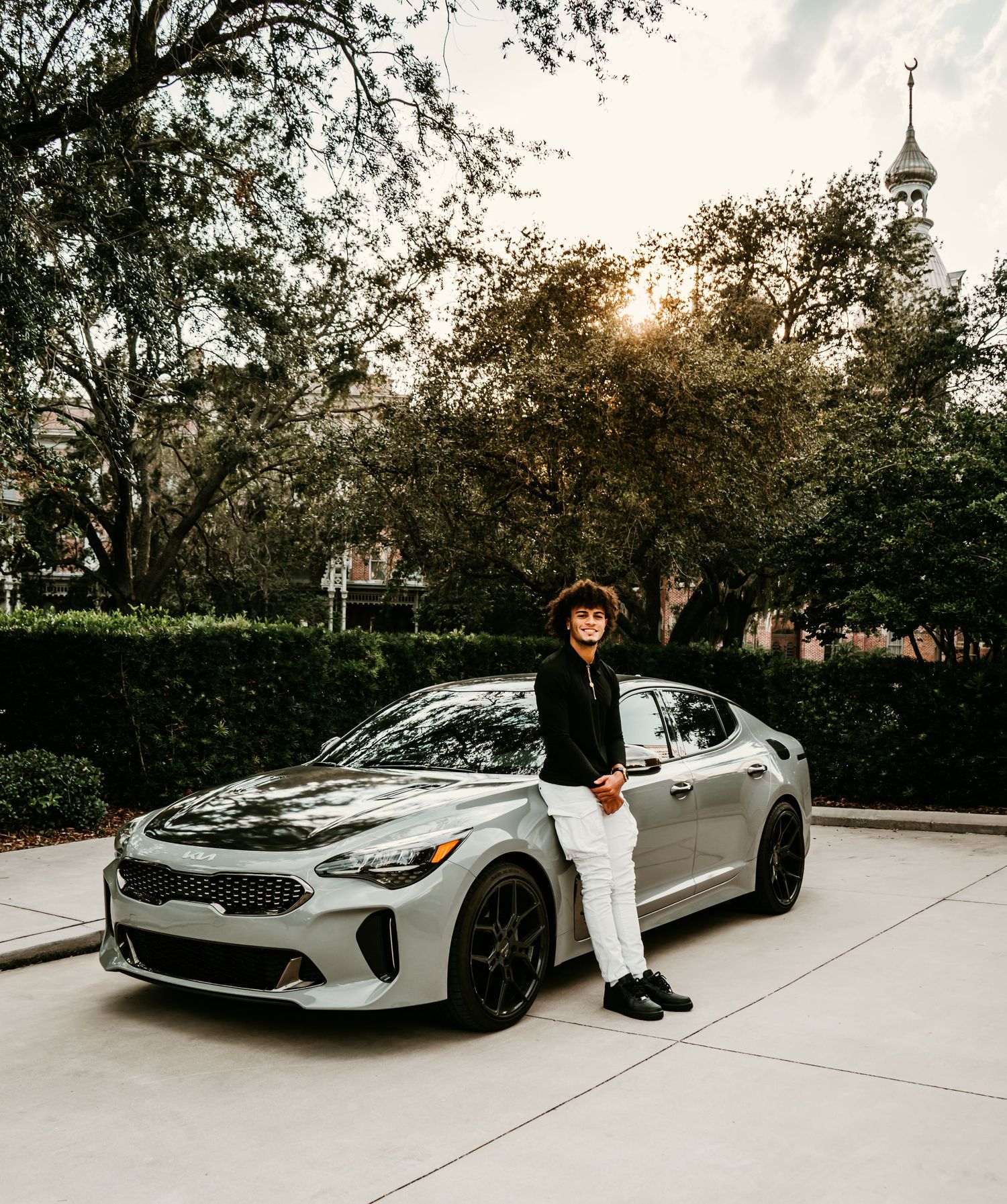 Outdoor Senior Portrait Session at University of Tampa in Tampa, FL; Senior photos, teen leaning on side of car