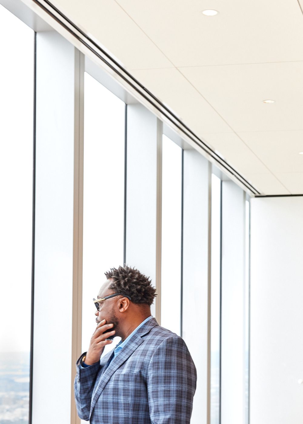 Man in a jacket looking through a window