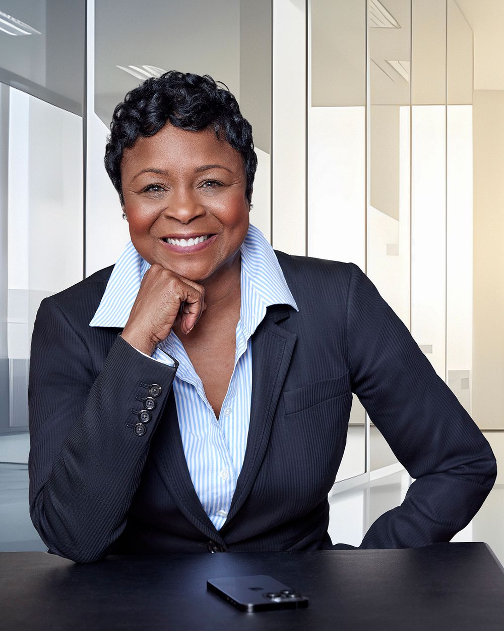 Woman in a black jacket sitting in a office