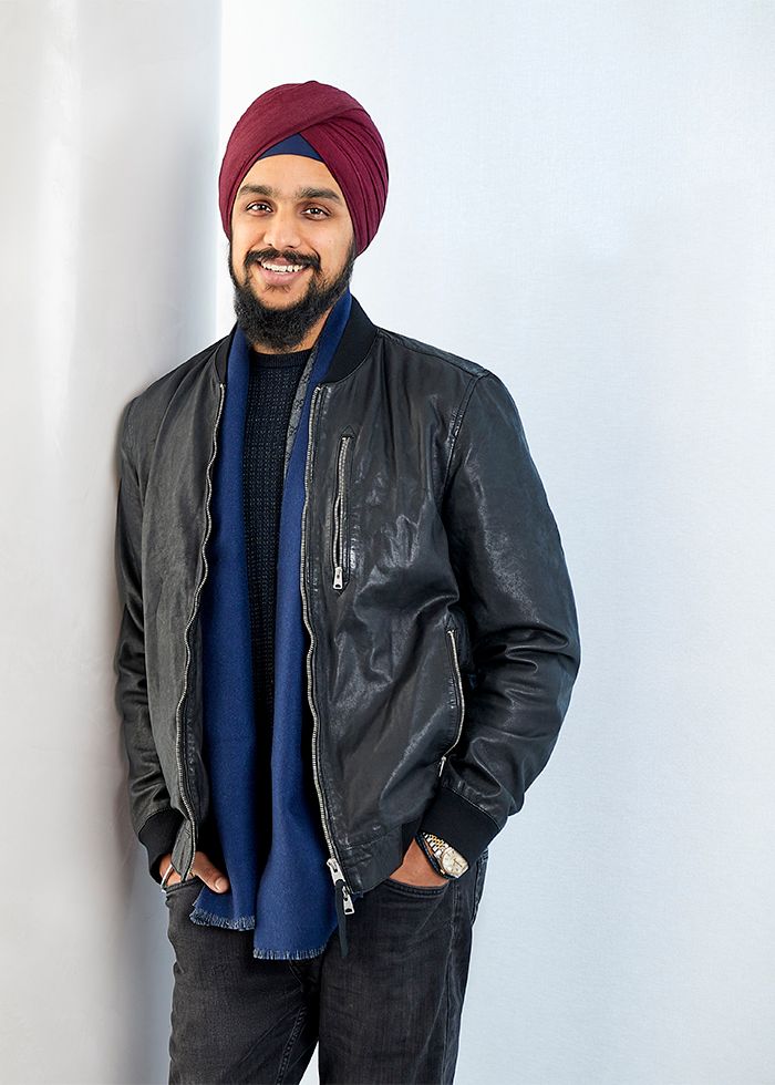 Portrait of a man standing against a wall