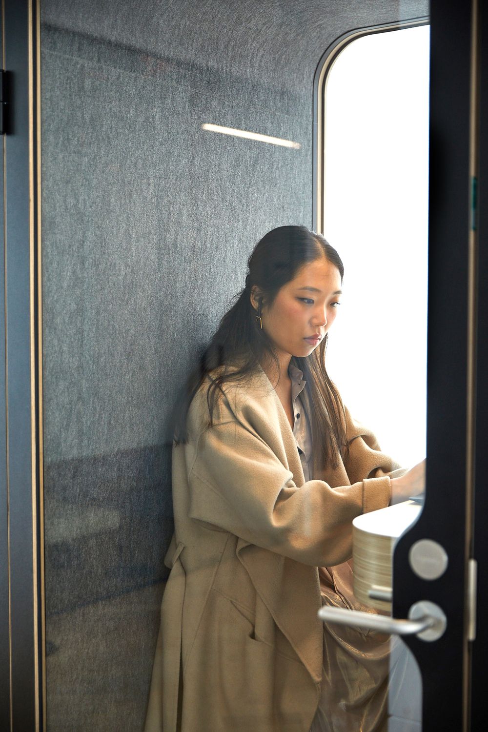 Waman in a beige dress working in a office
