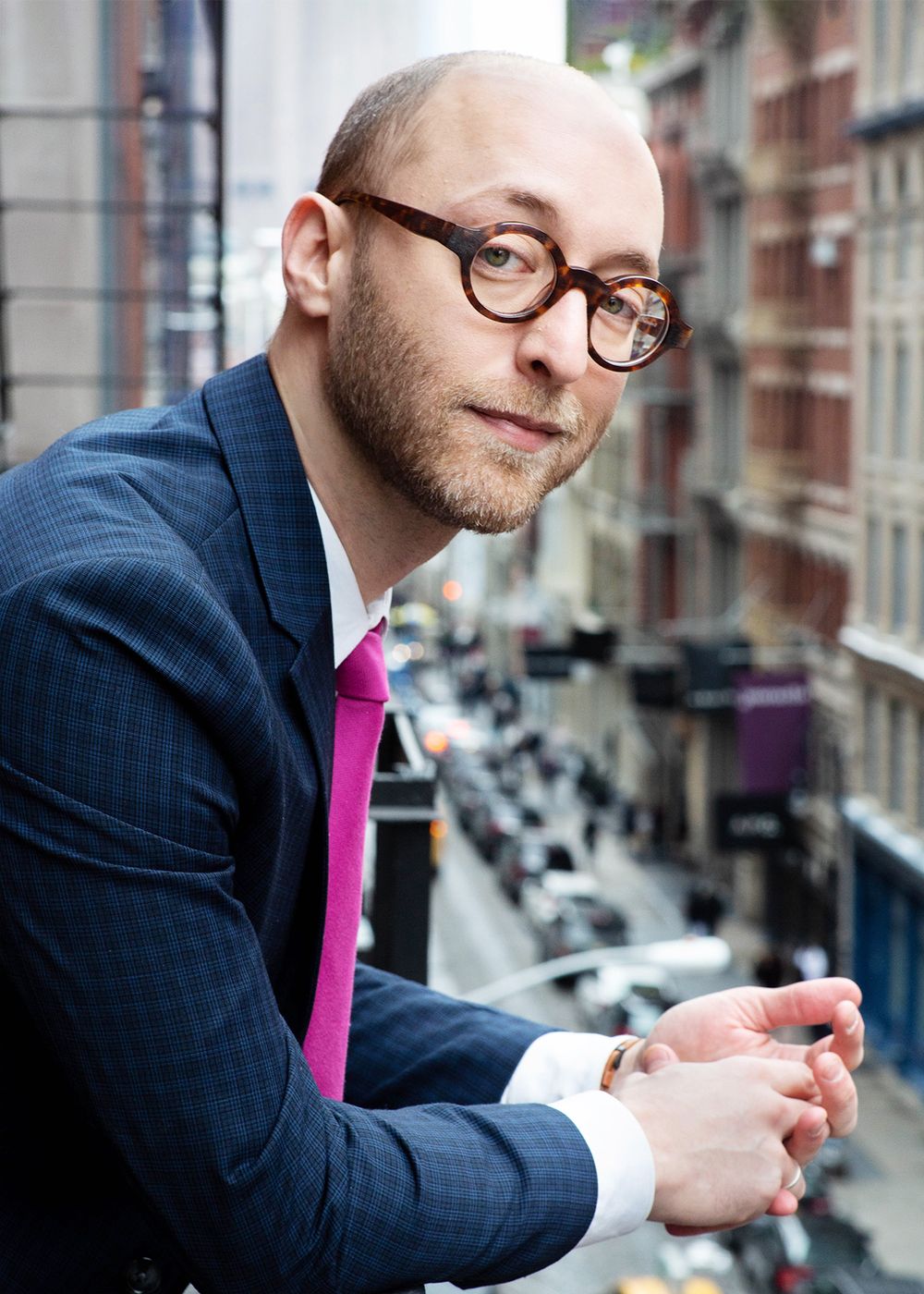 A man in a blue suit on the background of the city