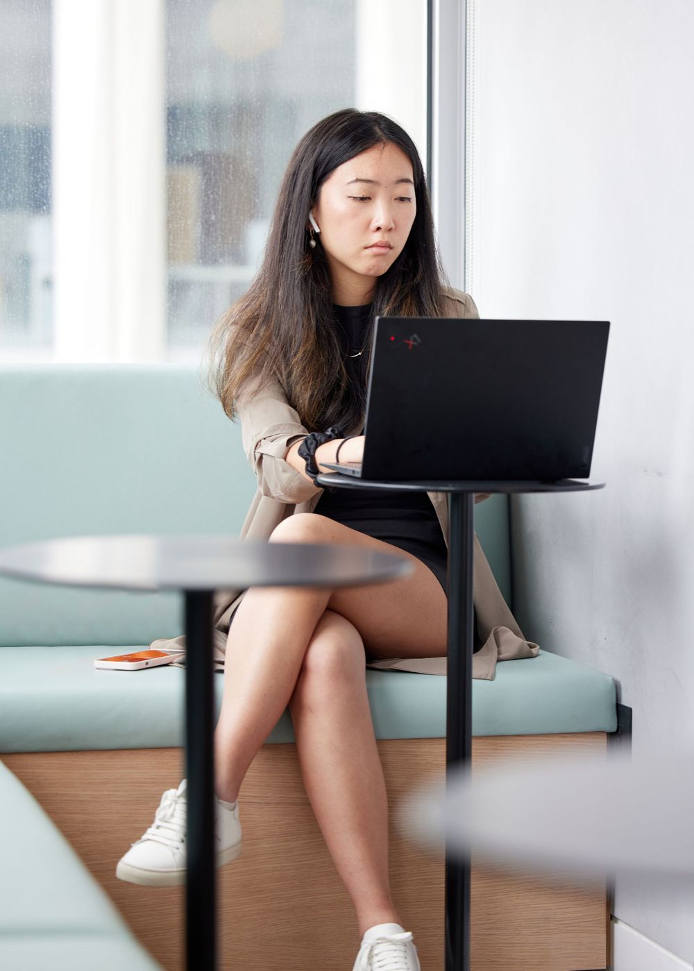 Woman sitting on a couch and working on a computer