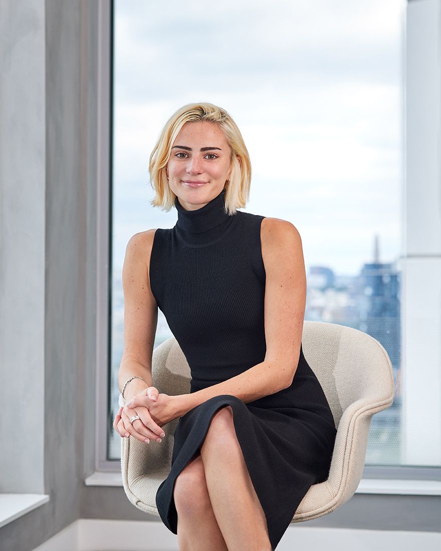 Blond hair woman in black dress sitting