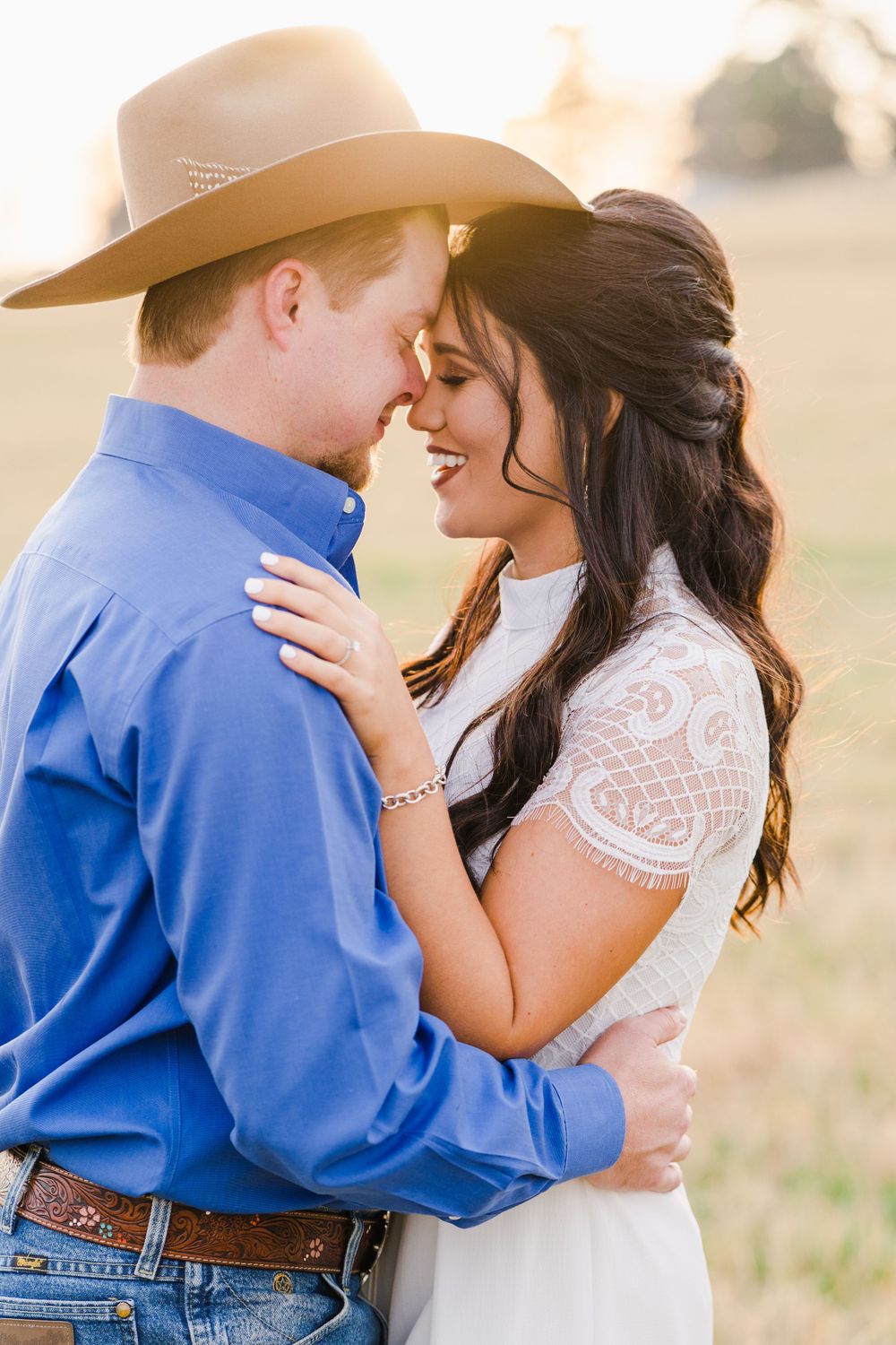 Intimate sunset portrait featuring western style and lace wedding dress.