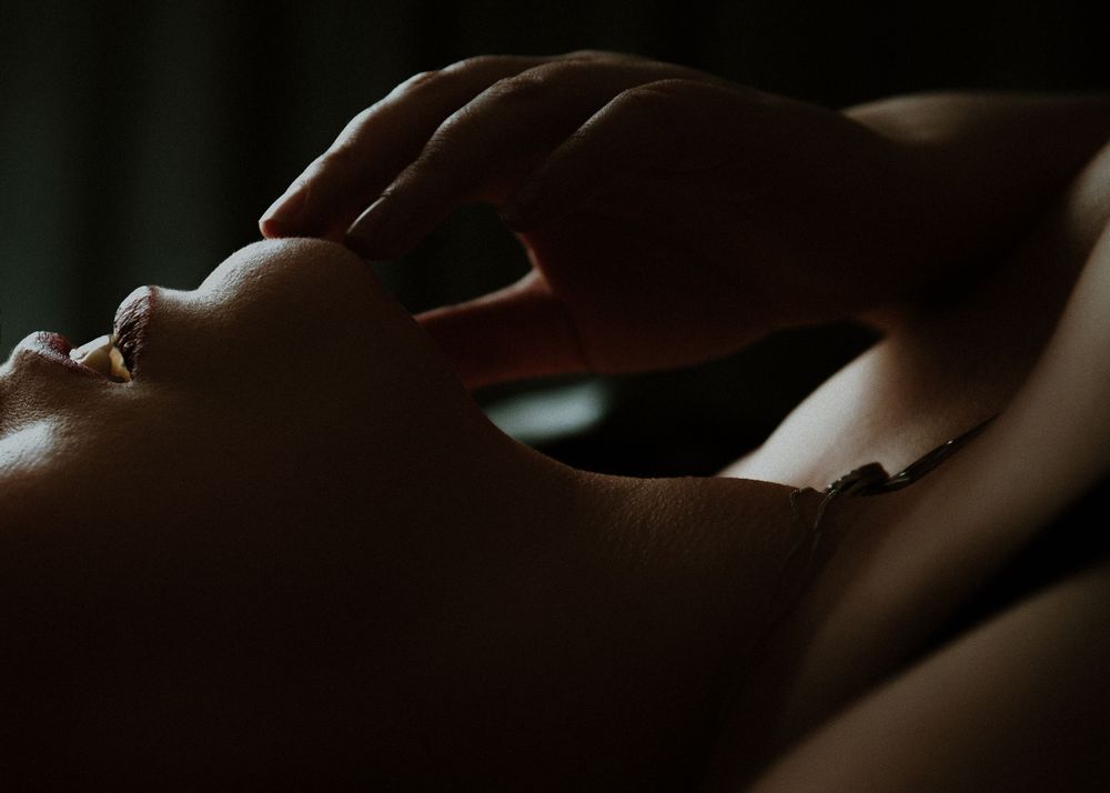 Dramatic shadowy profile portrait in intimate lighting.