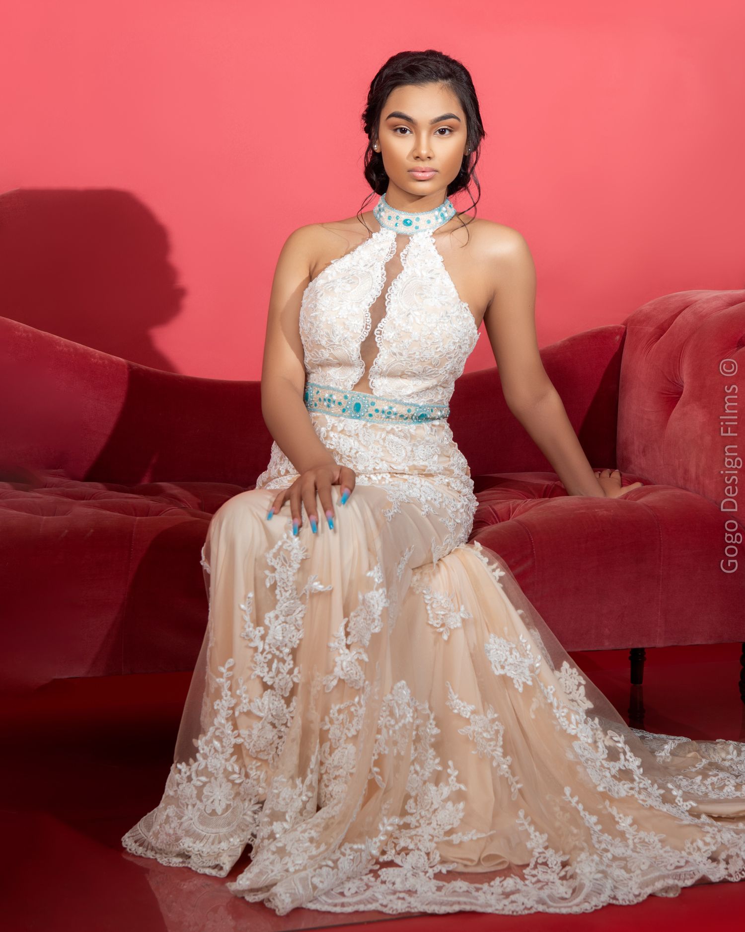 beautiful young lady in a long dress sitting on a red couch. Gogo Design Photography - Bridgeport CT