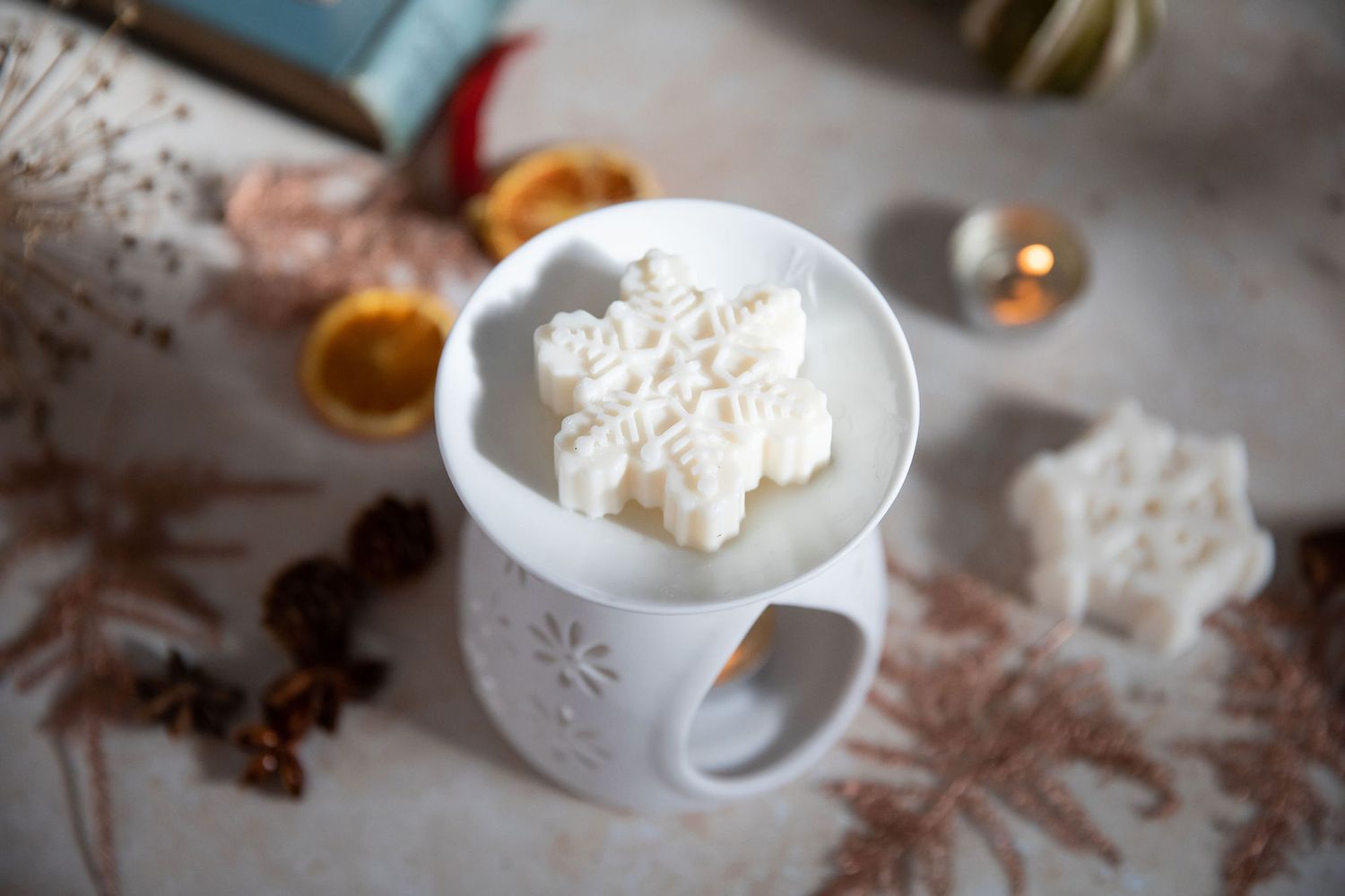 Hot chocolate topped with whipped cream in a snowflake-patterned white mug from a product photoshoot.