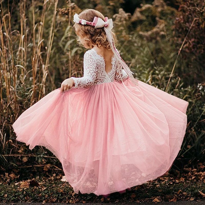 Pink princess dress with lace sleeves twirling in outdoor autumn setting.
