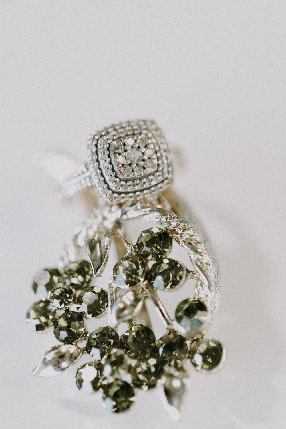 Close-up of an ornate diamond engagement ring with floral details.