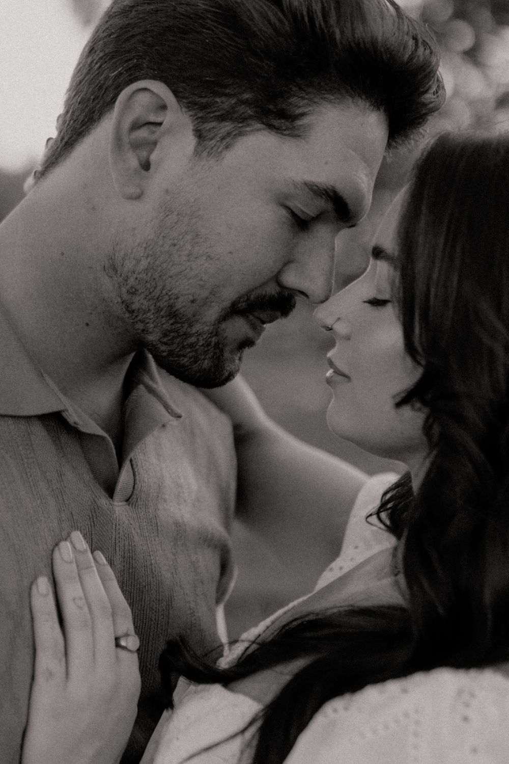 Black and white romantic photo series showing intimate close-up moments between a couple in an affectionate embrace.