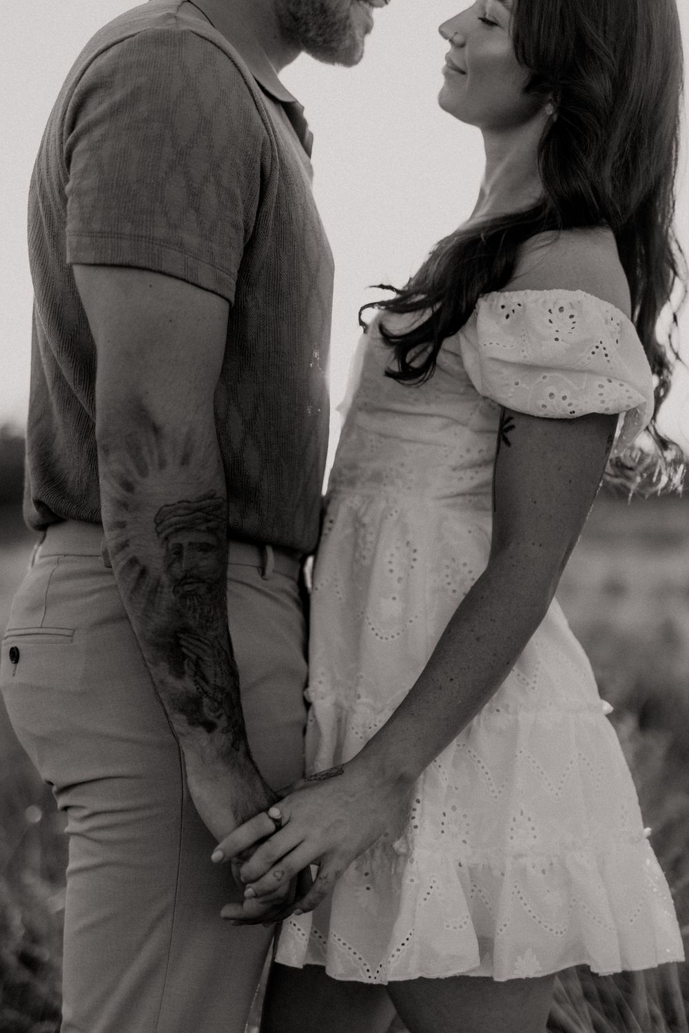 A romantic black and white photo series showing intimate moments between a couple in casual attire.
