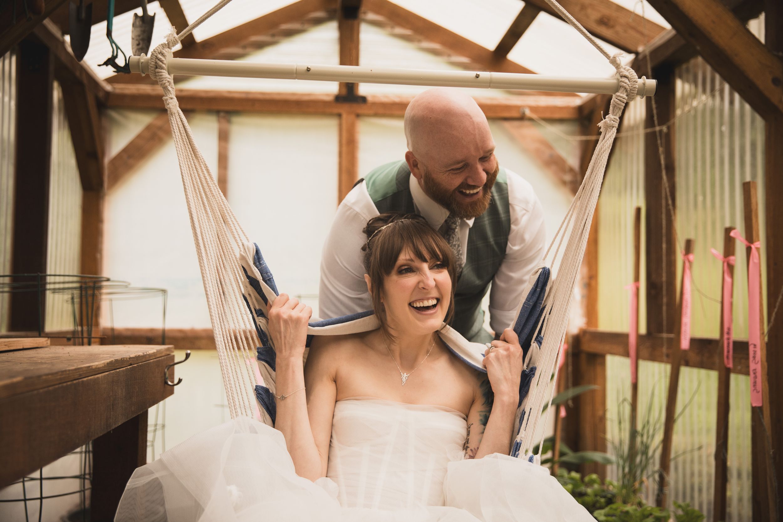 A joyful moment captured on a swing in a rustic barn setting.