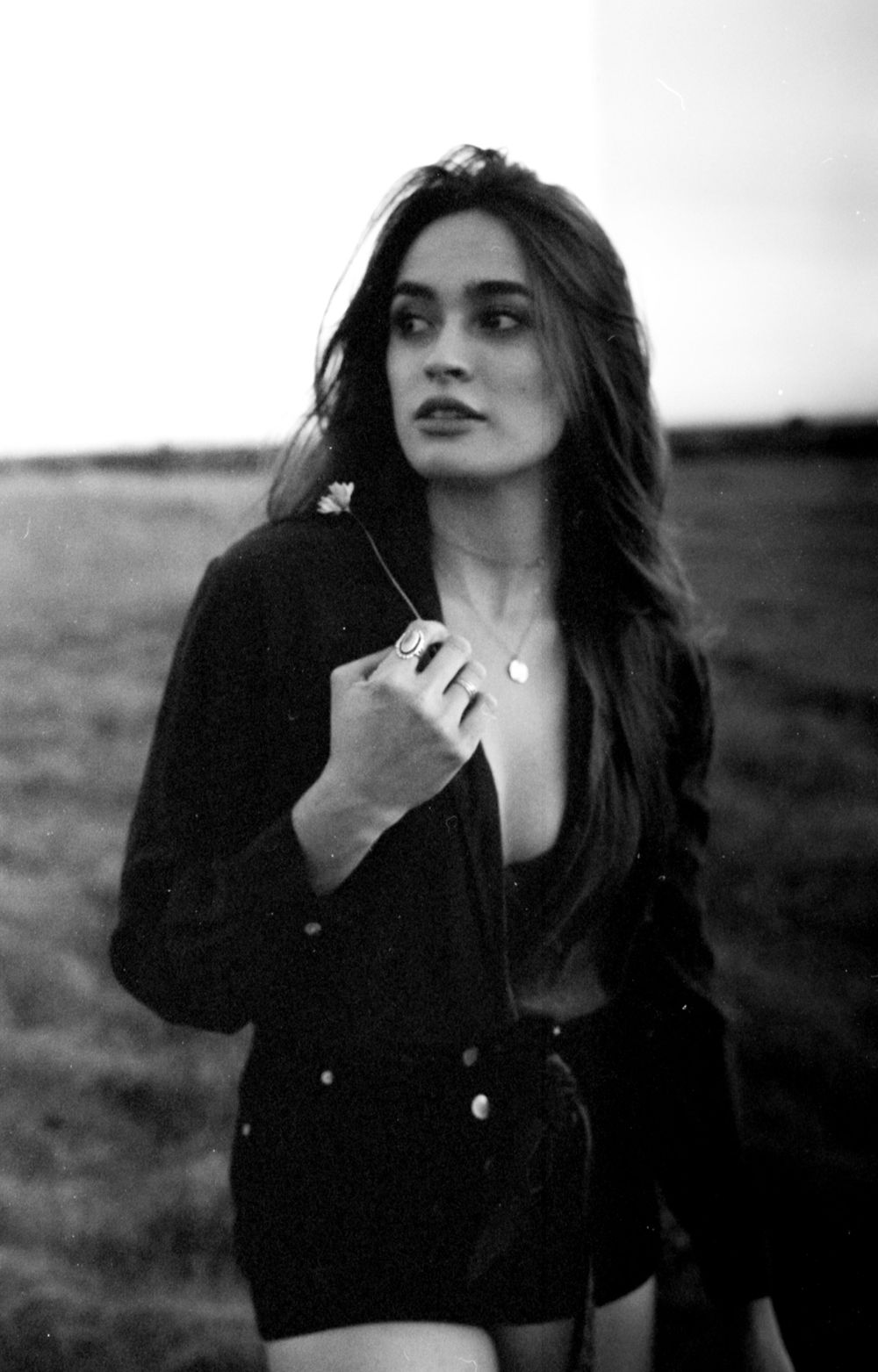 Atmospheric black and white portrait in natural outdoor setting.