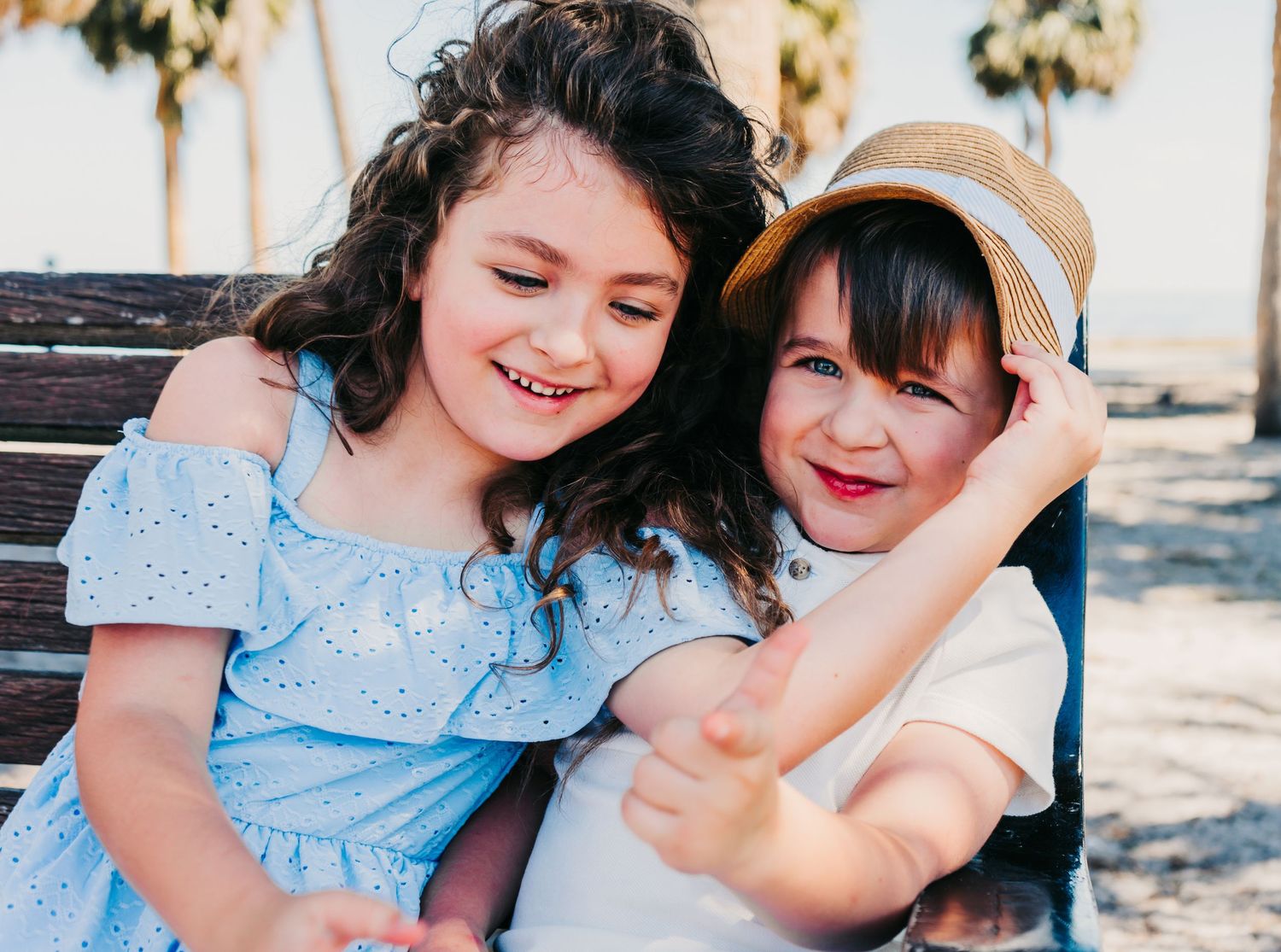 Outdoor Family Session at Vinoy Park in St. Pete, FL - Siblings laughing on park bench