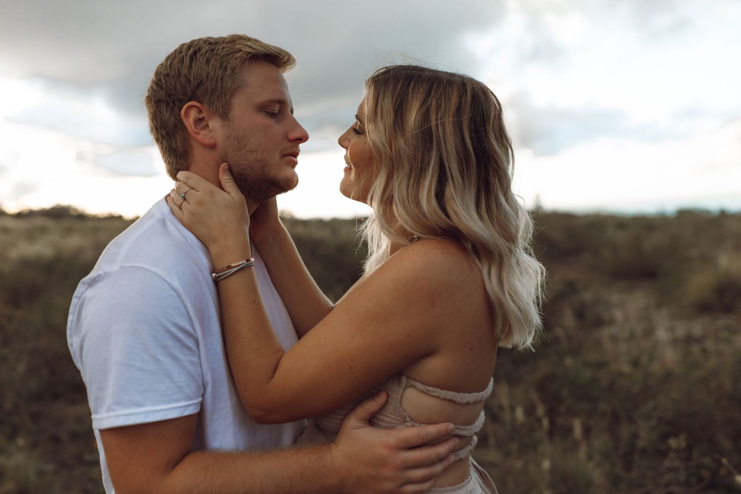 Engagement celebration couple in a field in hawaii