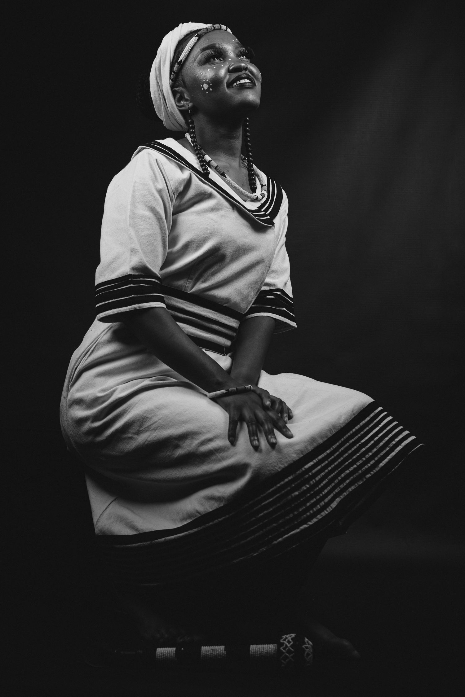 Studio shoot, of a lady celebrating her Xhosa heritage, dramatic and story telling images, black and white photo.