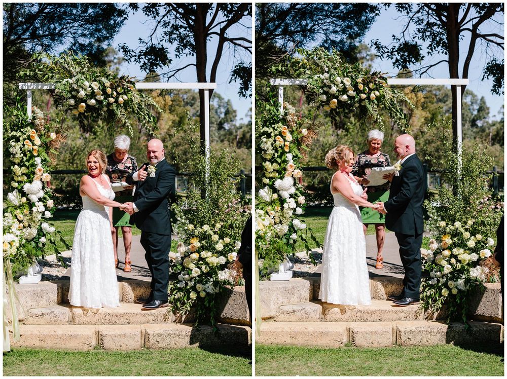 Wedding ceremony under floral arch with peach and white roses.