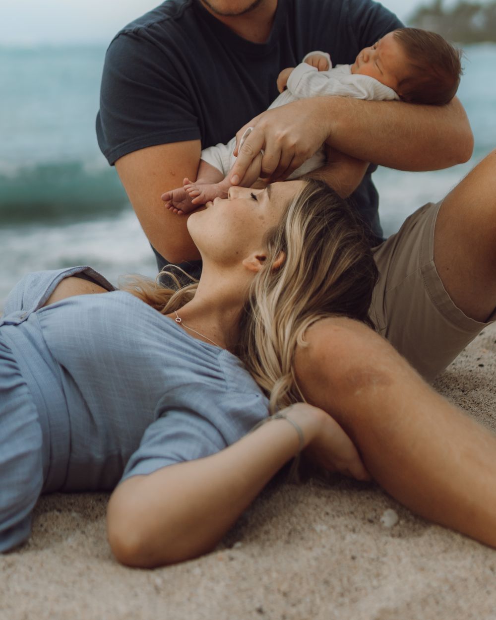 Family beach photo in Hawaii by the rocks big island photographer