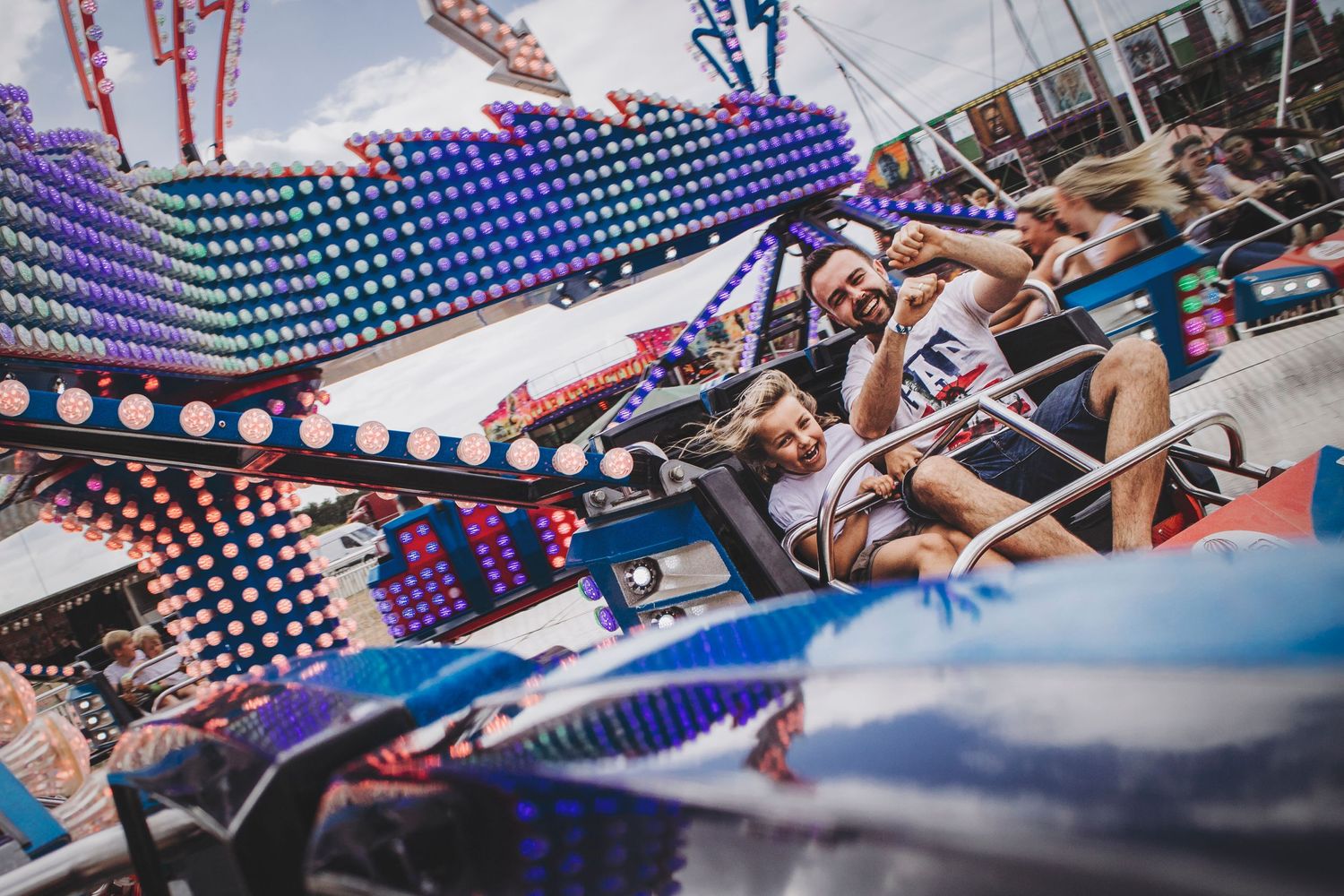 Colorful carnival ride with neon lights and motion blur creating an exciting atmospheric scene.
