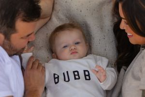 A mom and dad stare adoringly at their baby
