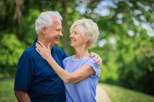 A husband and wife of 70years share a kiss