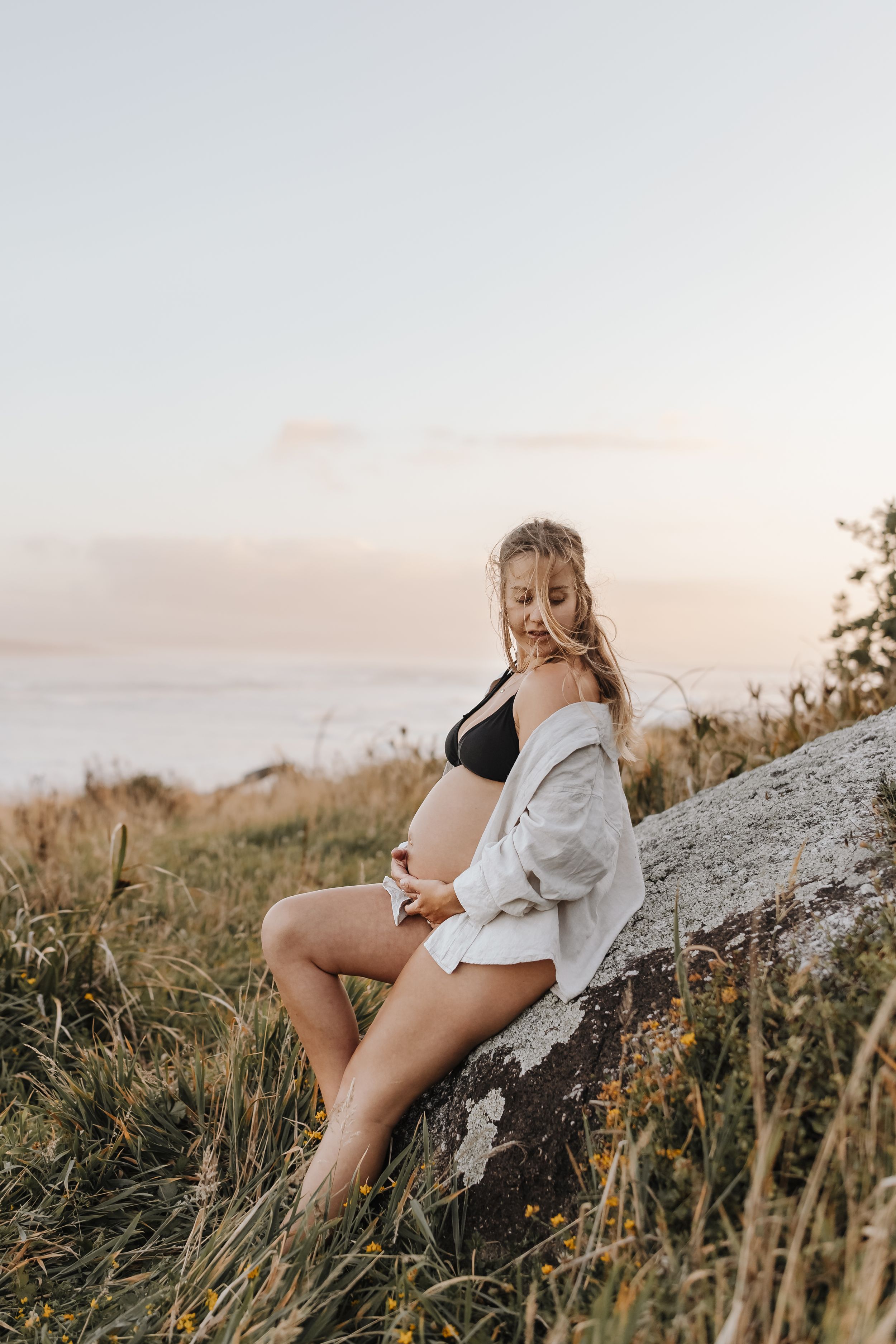 Maternity portrait of expectant mother on golden-hour beach Westport NZ