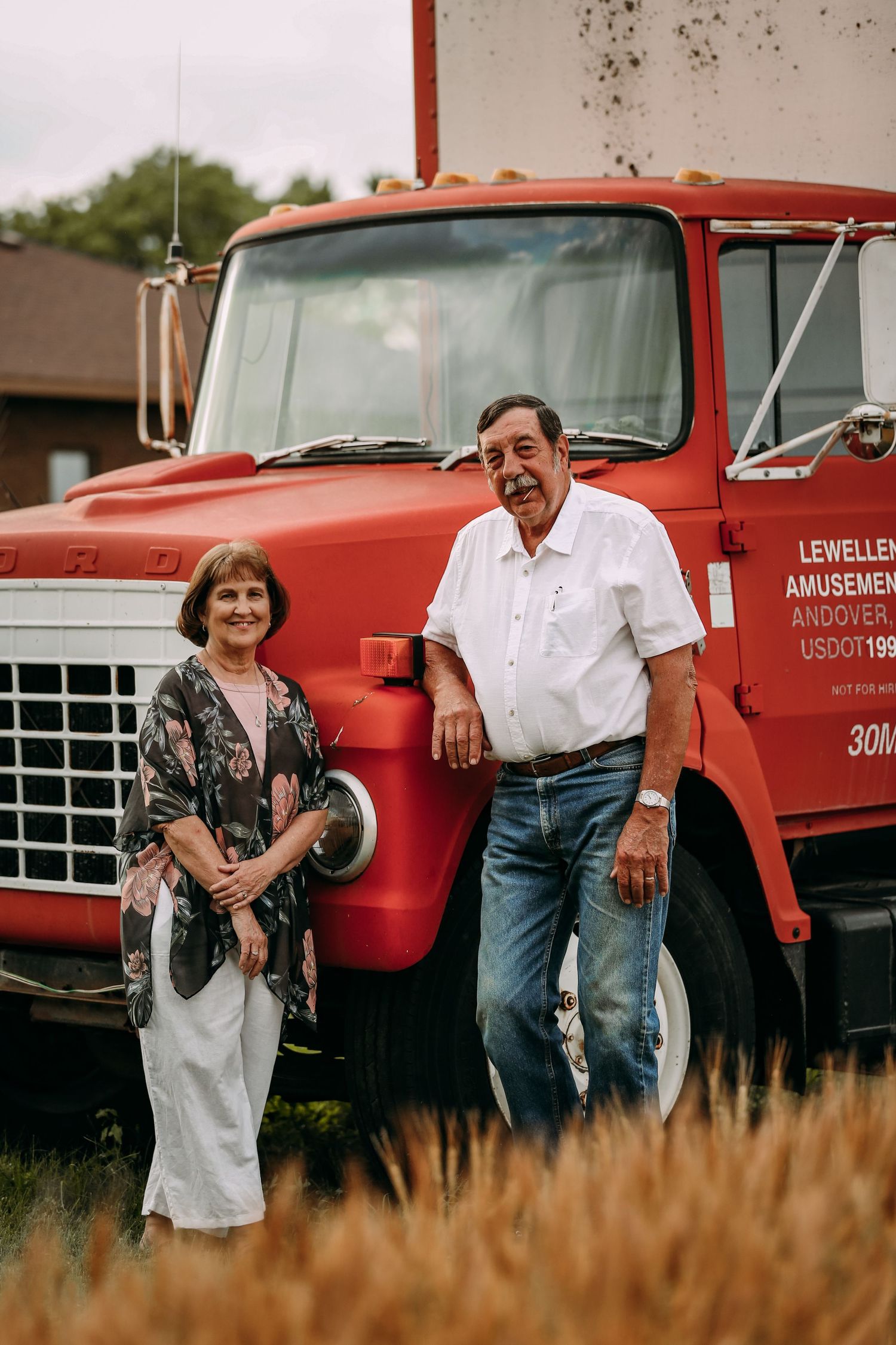 grandparents in front of hay truck