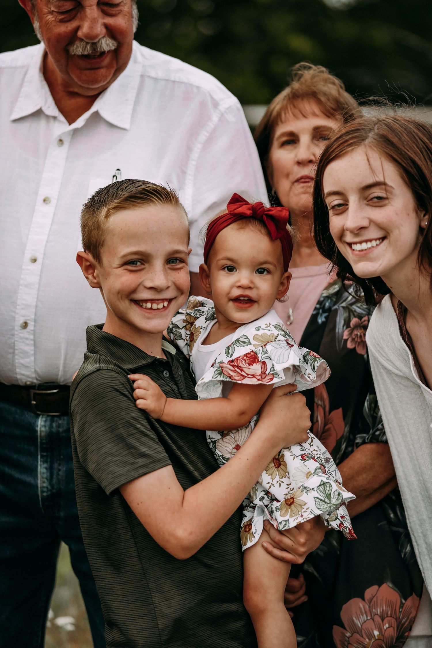 brother holding cousin in family portrait