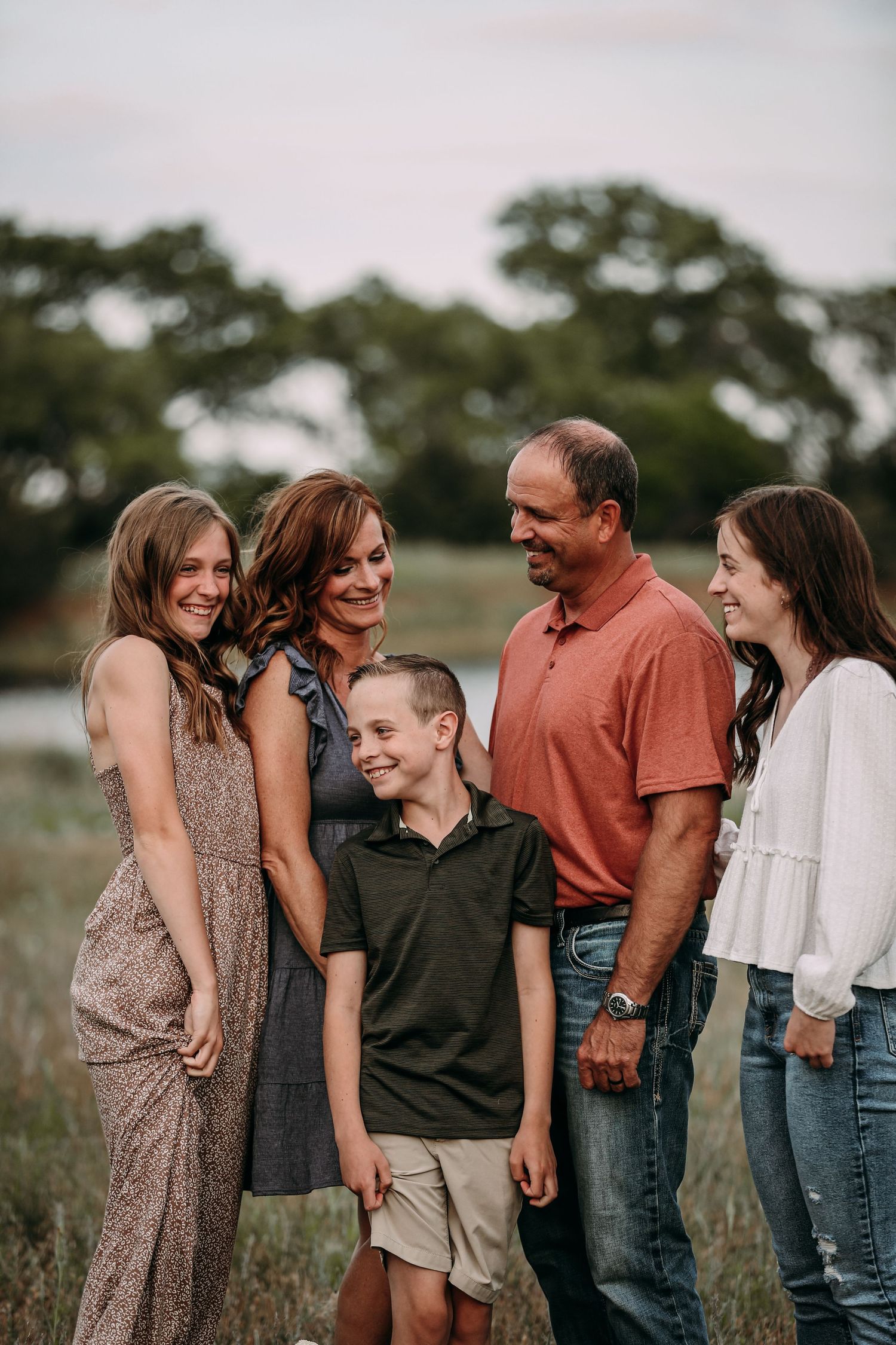 a family in a field laughing
