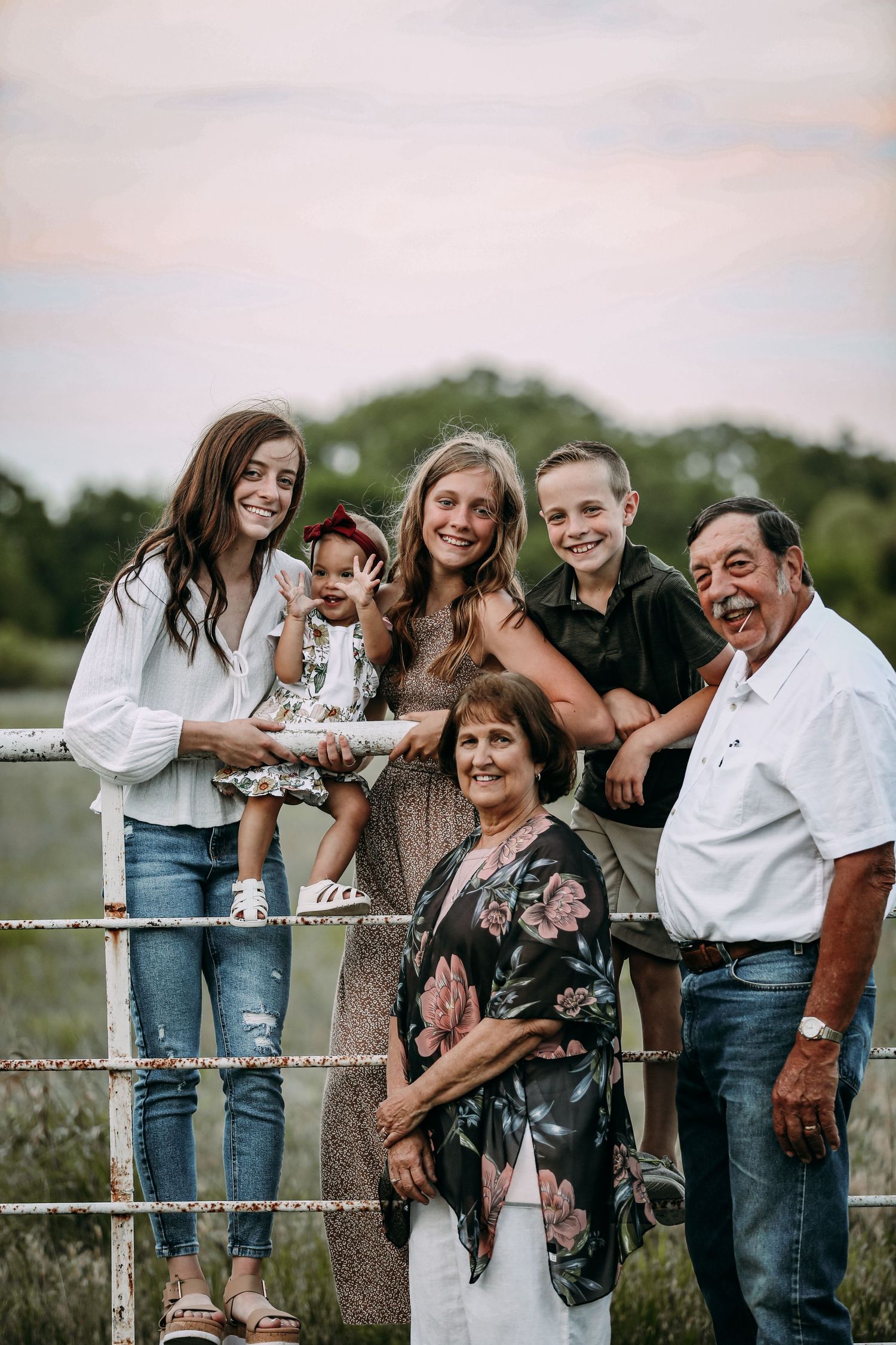 family posing on a fence
