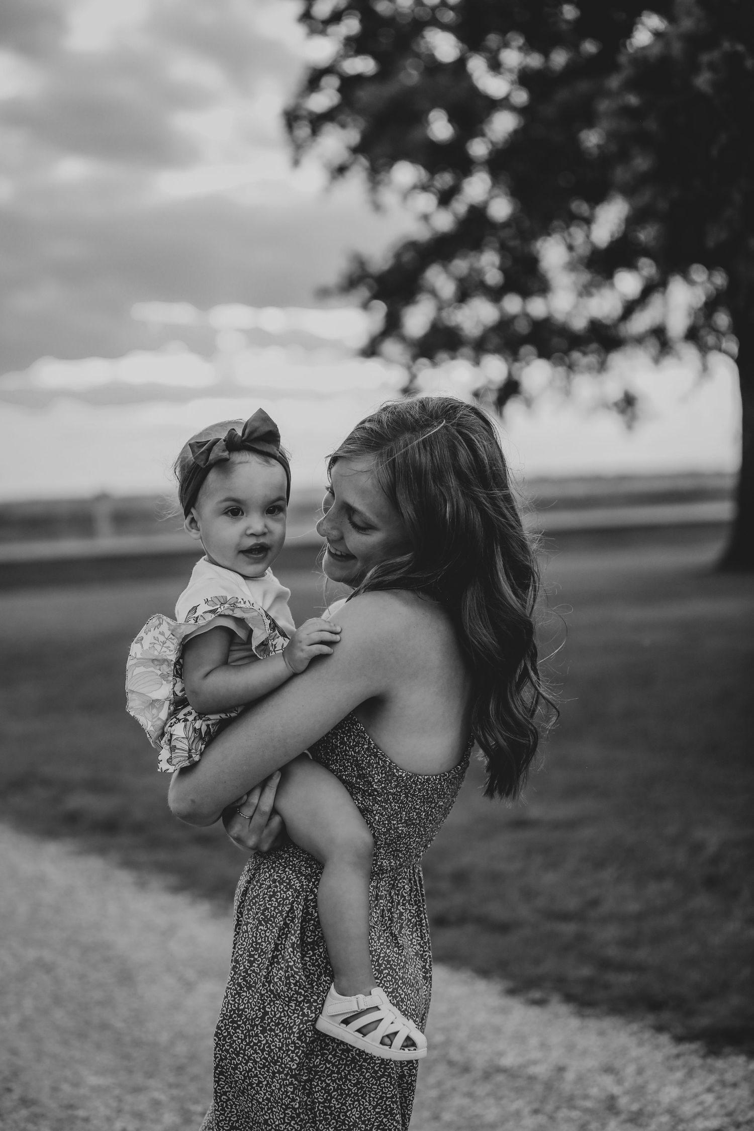 girl holding a baby in road