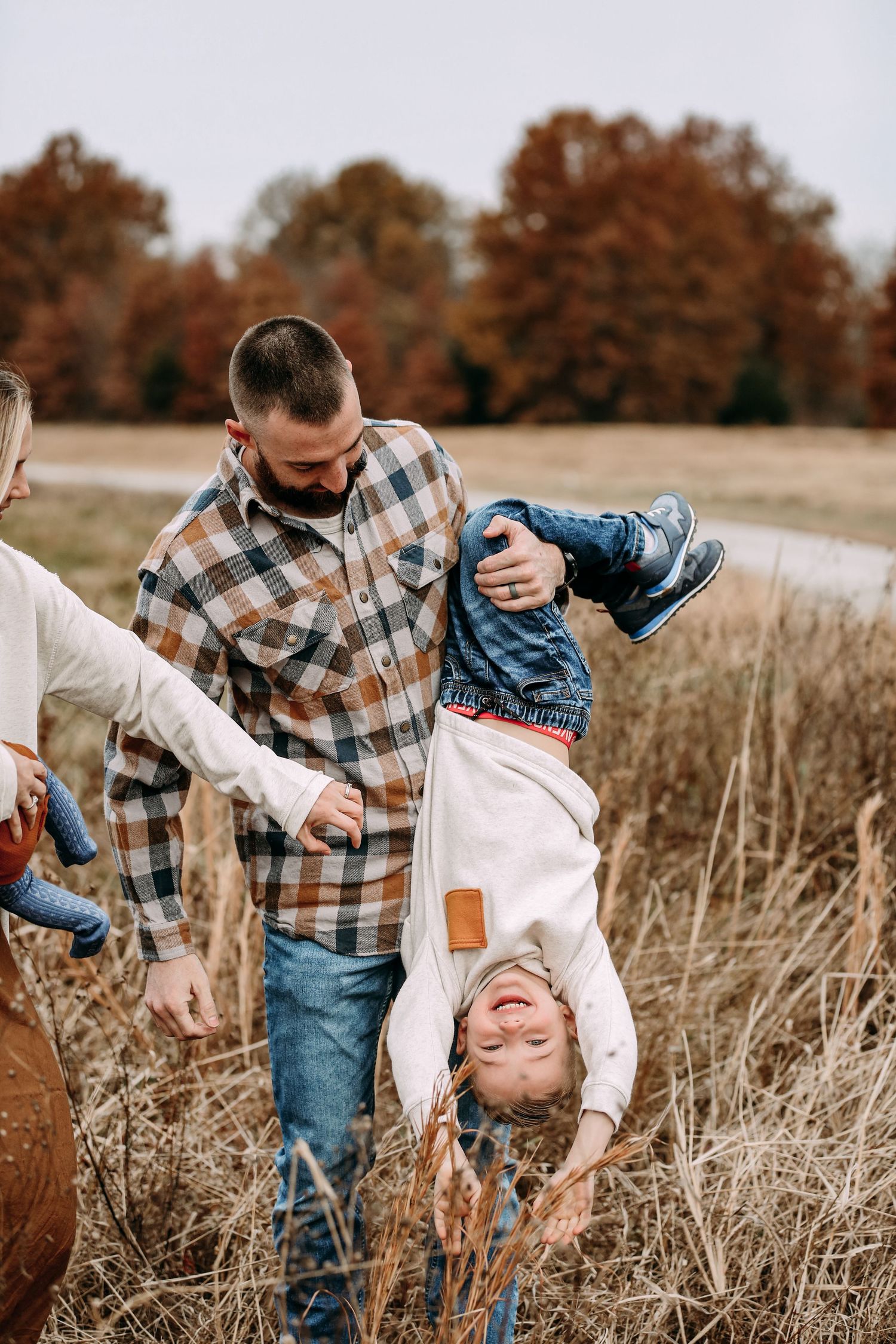 father playing with son in field