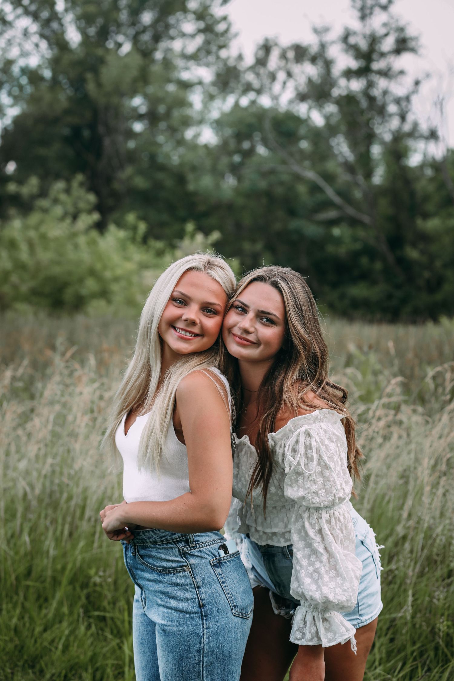 two sisters posing for camera