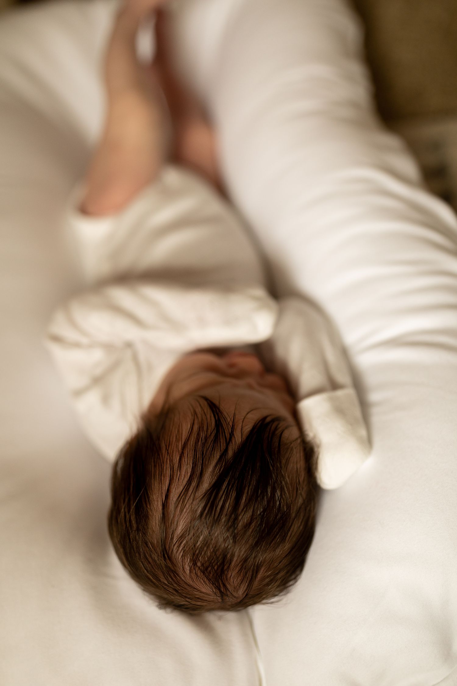 Close-up series showing brown hair against white pillows creating an artistic gradient effect.