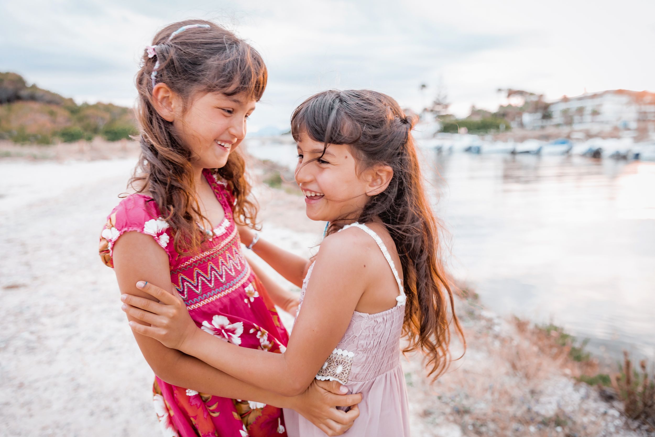 Two young sisters having fun during a family photo session in Mallorca.