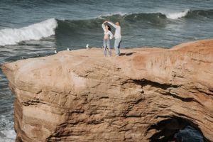 Rocky coastal landscape with ocean waves crashing against cliffs.
