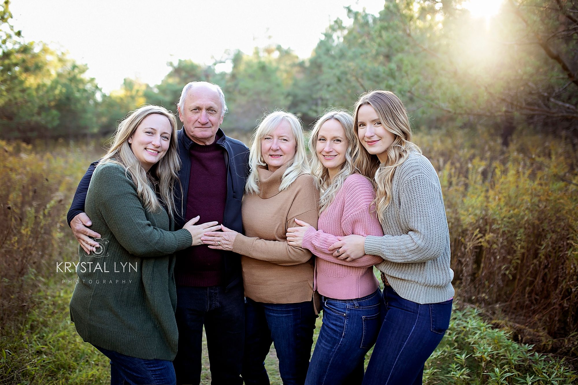 Three older sisters pose with their Mom and Dad for their Moms 60th birthday