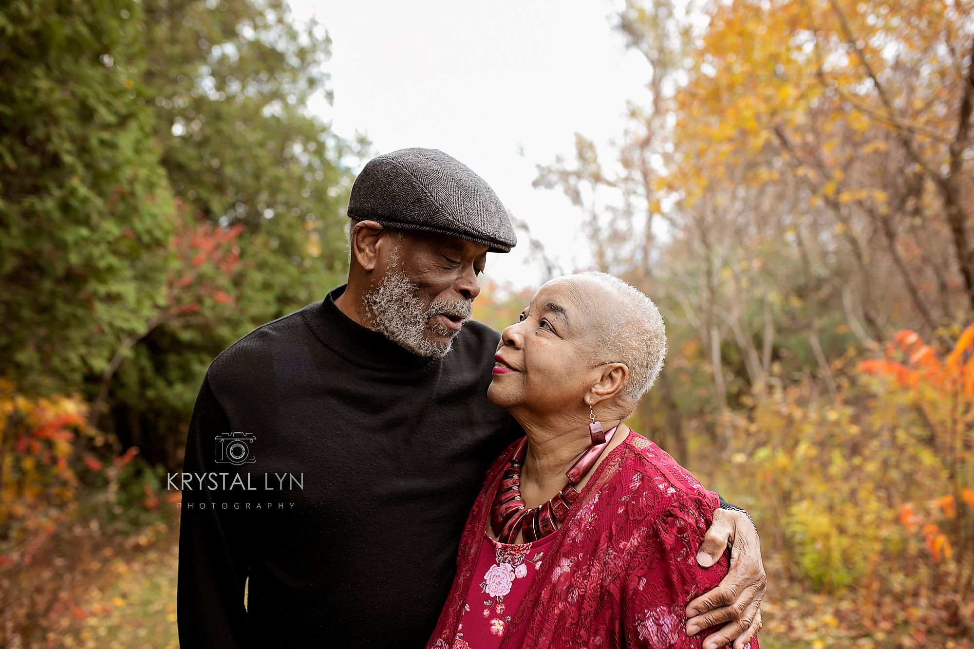 Wise married couple embrace for photo session