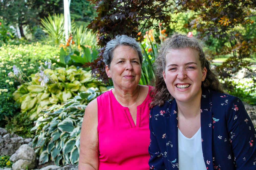 A Mother and Daughter sitting on rocks in the Gardens of the Oshawa Botanical Gardens