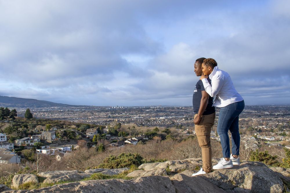 A man and woman gaze out over a view of the town
