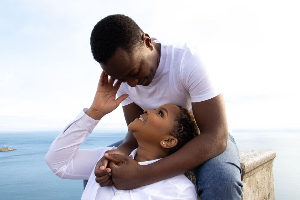 A man and a woman look at each other smiling