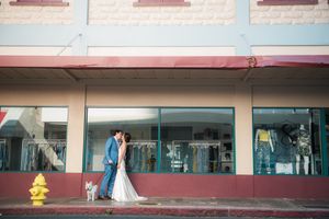 Wedding couple outside store with yellow fire hydrant