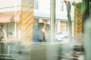 Wedding couple seen through downtown store window in Honolulu