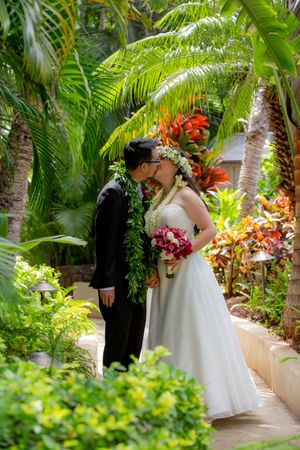 Wedding couple in middle of tropical greenery