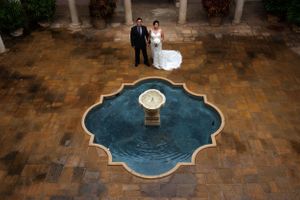 Courtyard of La Pietra School with wedding couple standing above fountain