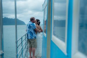 Bridal couple kissing on boat