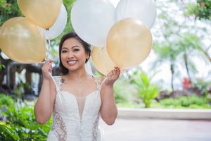 Bride with white and gold balloons